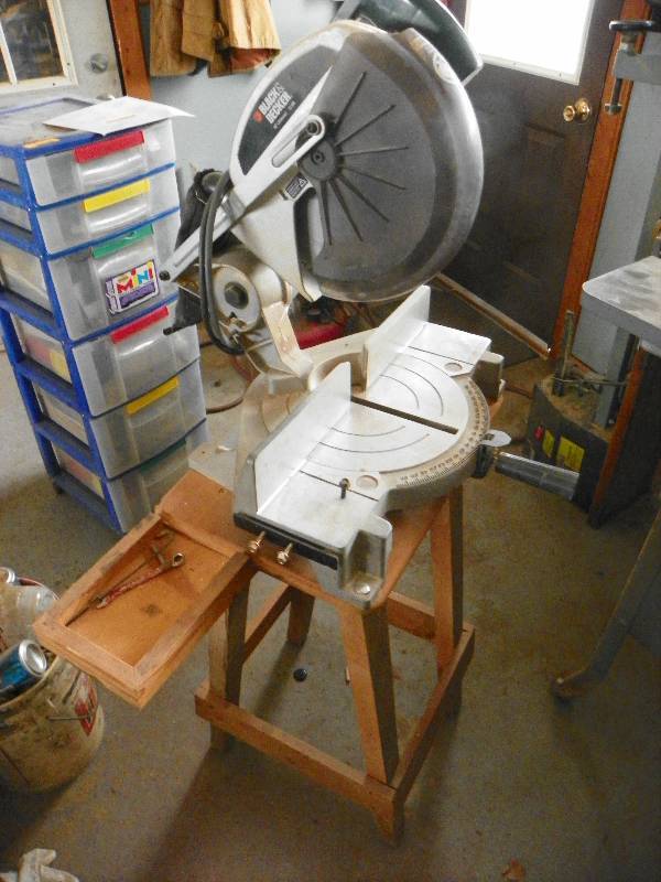 lot 4 image: Electric Miter saw mounted on small table.