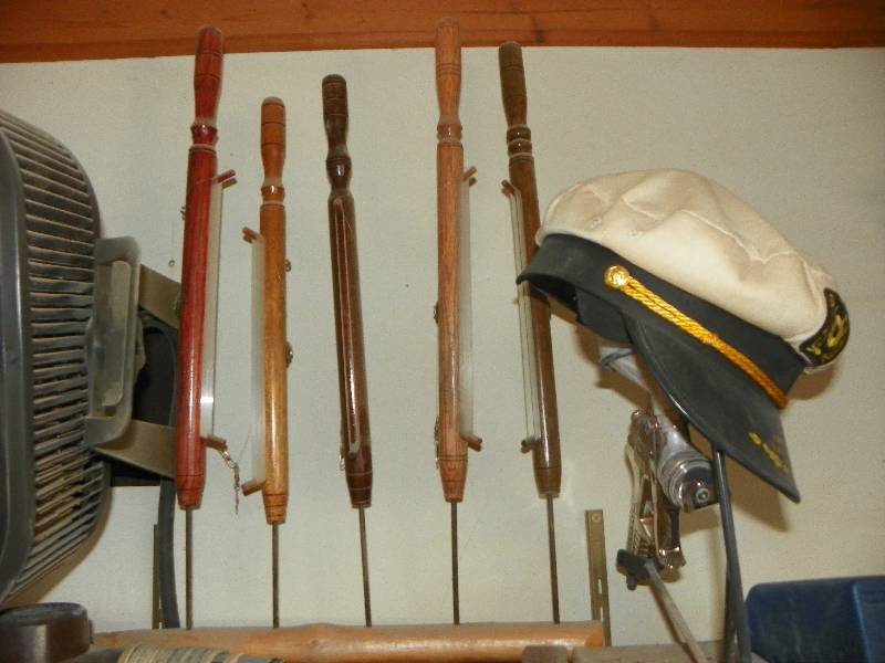 lot 41 image: Ice Fishing poles, captains hat and spray gun stand