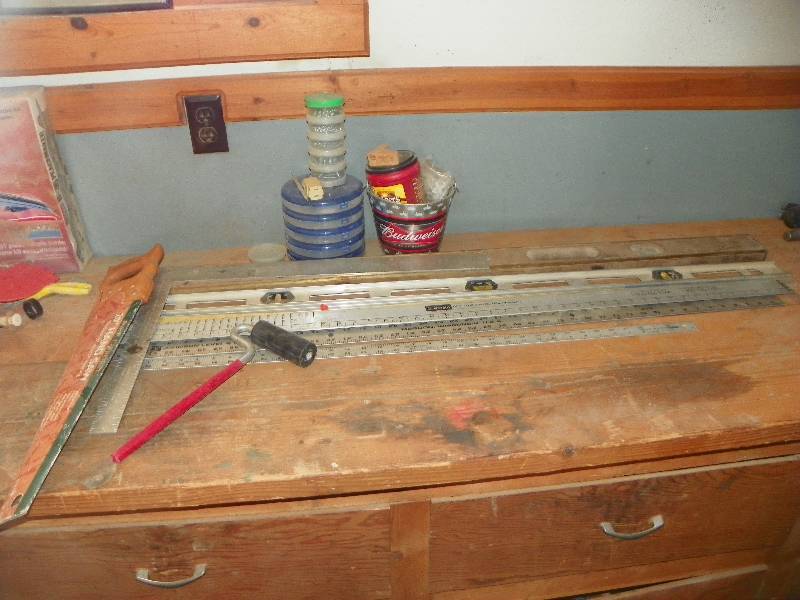 lot 70 image: Rulers, level, hand saw, small roller, and misc