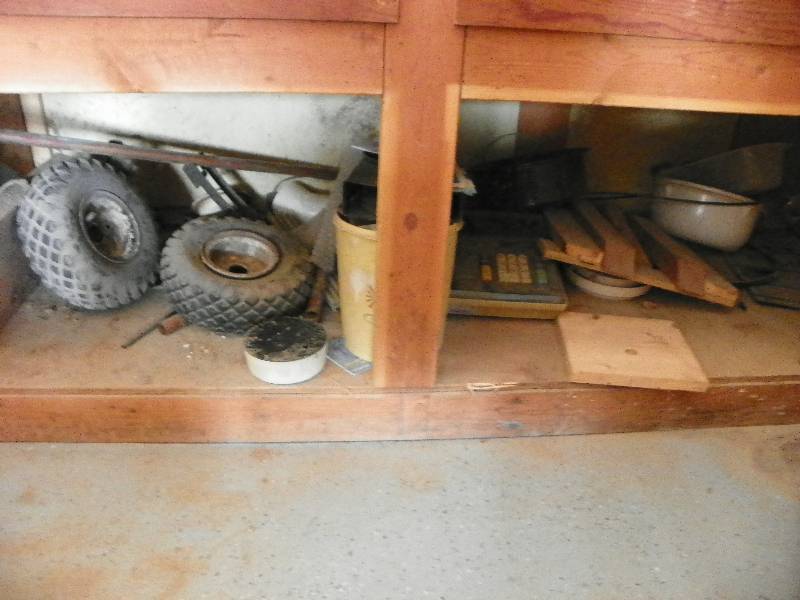 lot 80 image: Items under bench, two tires, wood pieces, and misc items