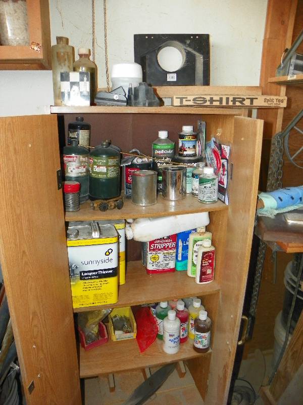 lot 84 image: Cabinet with contents, saw blade clock and cuckoo clock