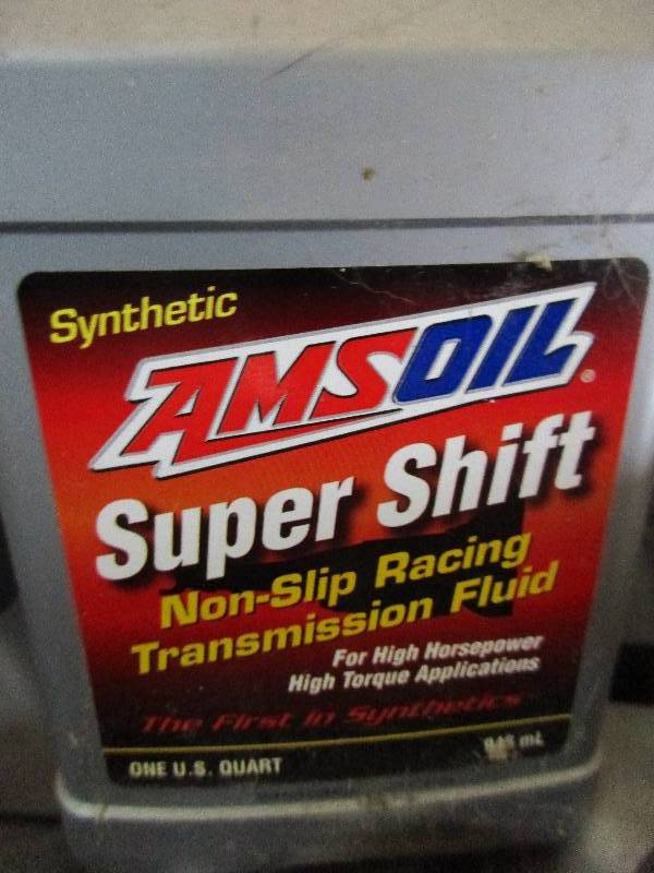 lot 7 image: 8 quarts Amsoil super shift non slip transmission fluid