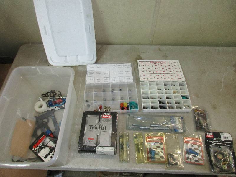 lot 20 image: tote of Holley carburetor parts