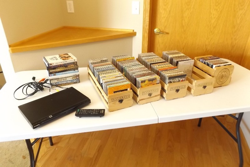 lot 12 image: Large Lot of DVDs, CDs and DVD Player.