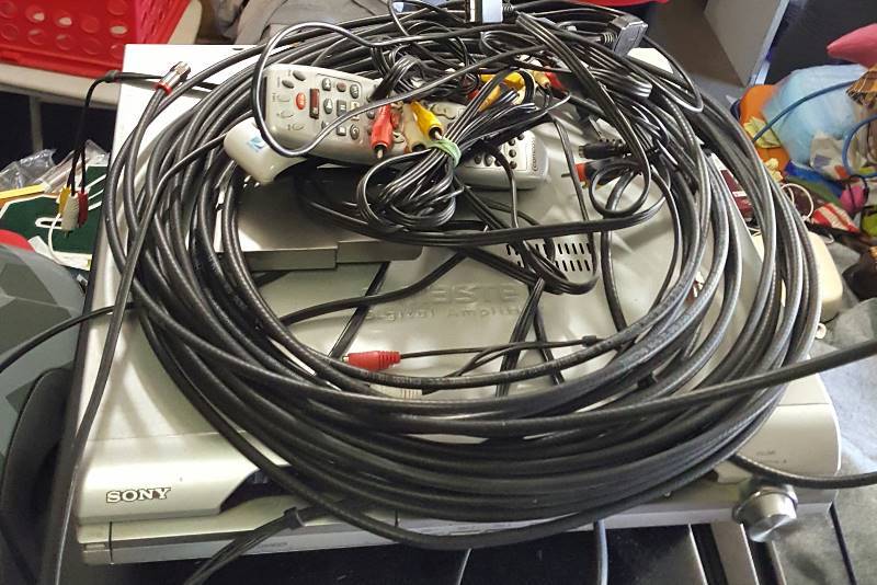 Lot of wires, dvd player, and Direct TV box