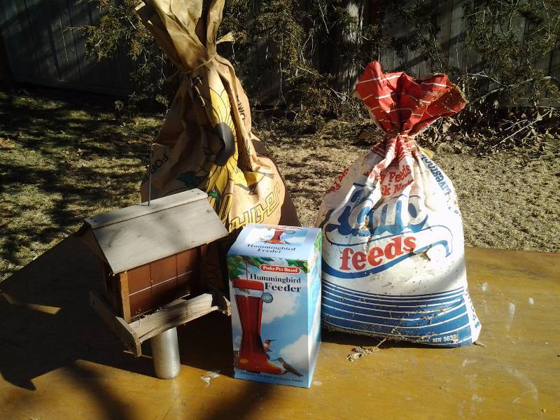 lot 54 image: 2-Bird Feeders, 2-Partial Bags FeedSeed