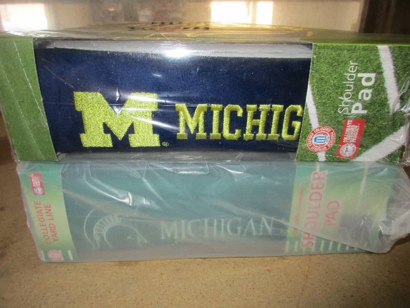 8 shoulder pads - 4 University of Michigan and 4 Michigan state