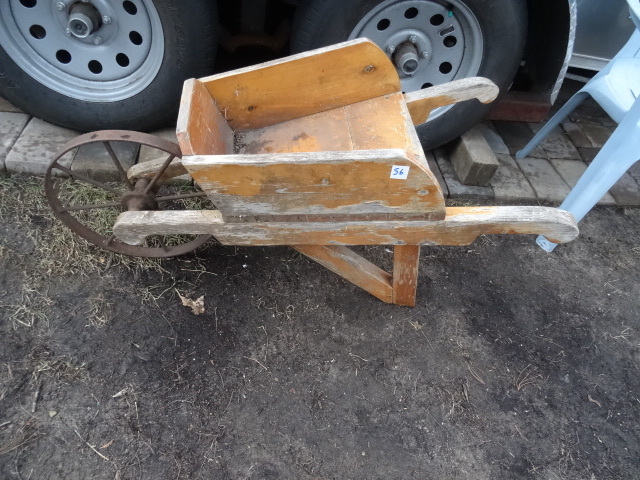 Decorative wood wheel barrow. Used as a outdoor pot holder