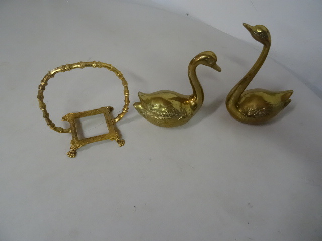 2 brass swans and a brass carrier.