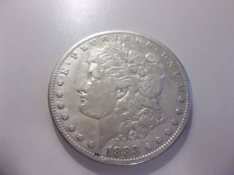 1883 S Morgan Silver Dollar Better Grade (In AU Valued At $145.00)