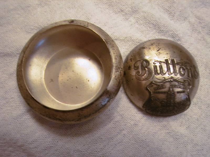 lot 28 image: Metal button container from the central high school of Faribault  (dated back in the 1800s)