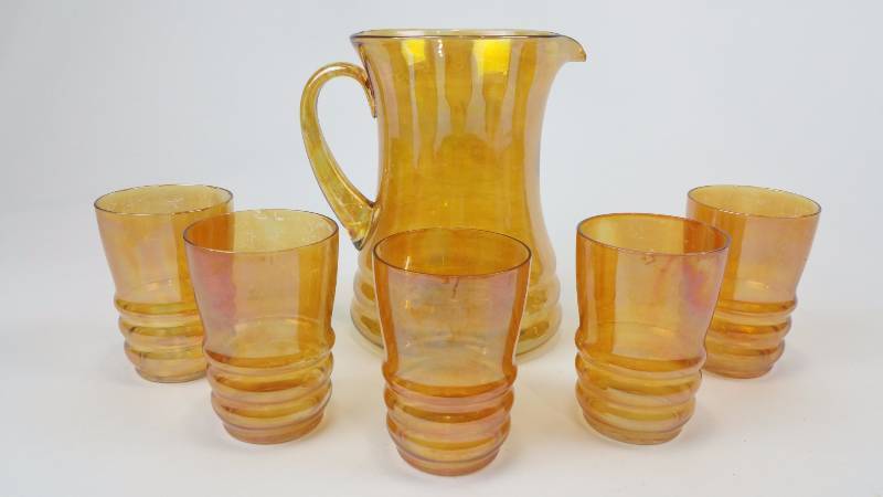 lot 82 image: Marigold Carnival Glass Iridescent Pitcher and Glass Set