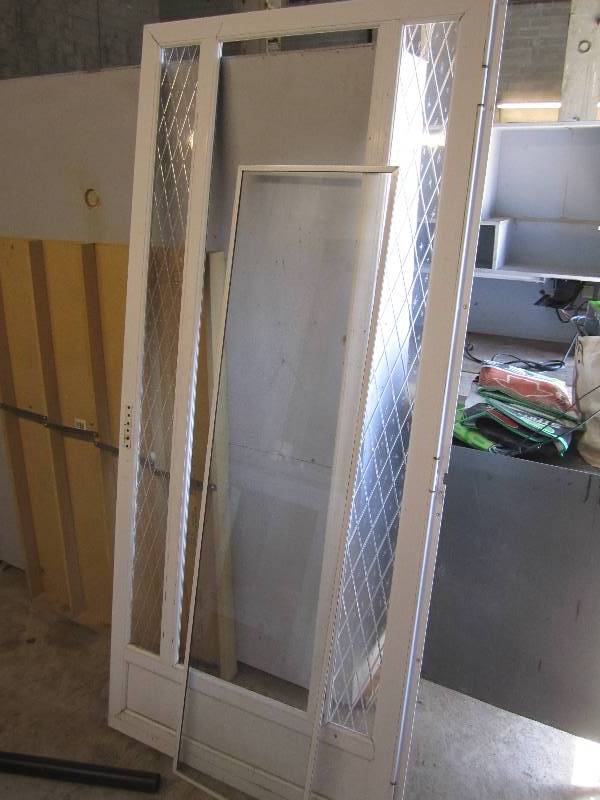 lot 55 image: Storm door with glass window...