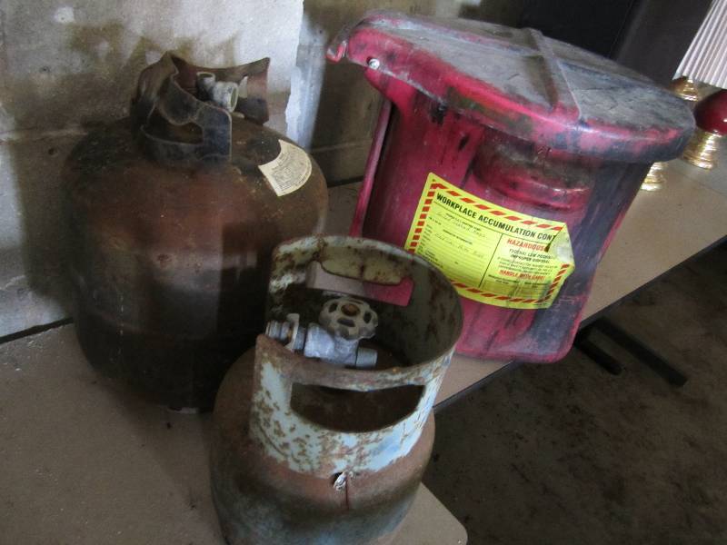 lot 72 image: 2 older propane tanks and a flammab...