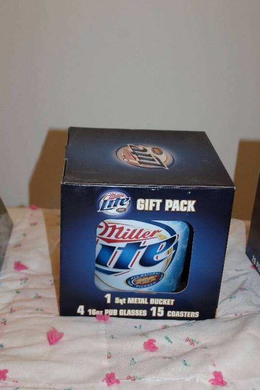 lot 21 image: Miller Lite Gift Pack w 5-Quart Ice Bucket, 4-16oz. Pub Glasses, 15-Coasters