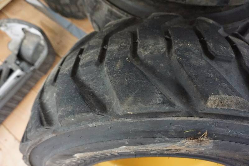 lot 14 image: Set of 4 - Caterpillar Brand Skid Loader Skid Steer Tires and Rim