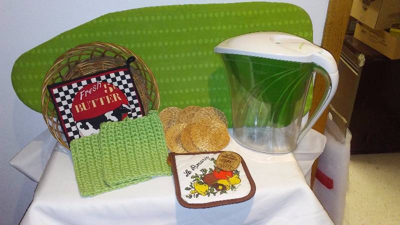 lot 58 image: Misc. Kitchen  Table top ironing board, Water Filter Pitcher, Hot pads and coasters.