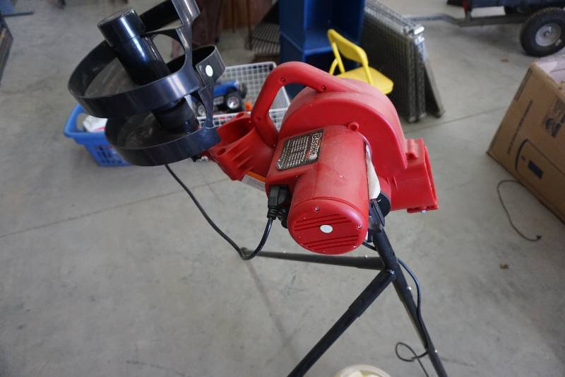 lot 18 image: Base Hit Brand Electric Baseball Pitching Machine With Balls