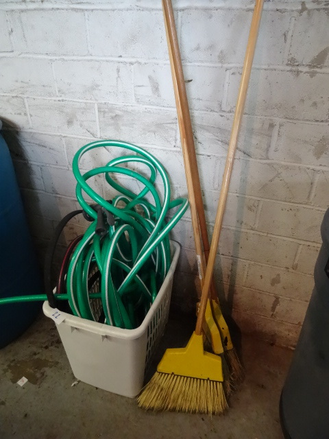 Misc garden hose. 3 brooms...