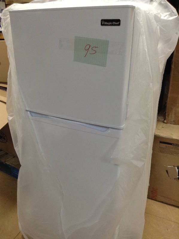 lot 95 image: Magic Chef 9.9 cu. ft. Top Freezer Refrigerator in White never used dent on side of door see pictures