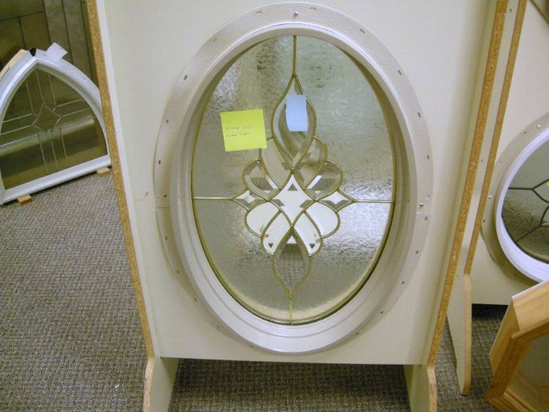 lot 60 image: Oval Brass Sunday Swirl Window