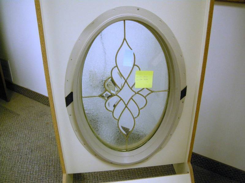 lot 61 image: Oval Brass Sunday Swirl Window