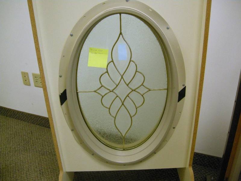 lot 68 image: Oval Brass Sunday Swirl Window