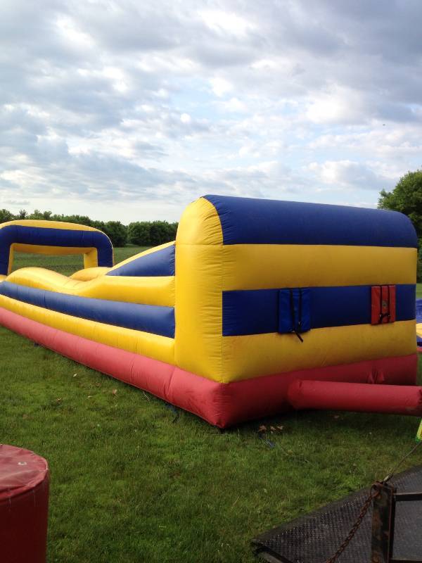 lot 1C image: 2 lane bungee run inflatable. Working condition. Great for rentals. Run as fast as you can before the bungee pulls you back. No blower included.