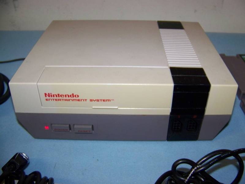 lot 106 image: Nintendo Entertainment System, Video Game Unit, (2) Controllers, Cables and (3) Game Cartridges