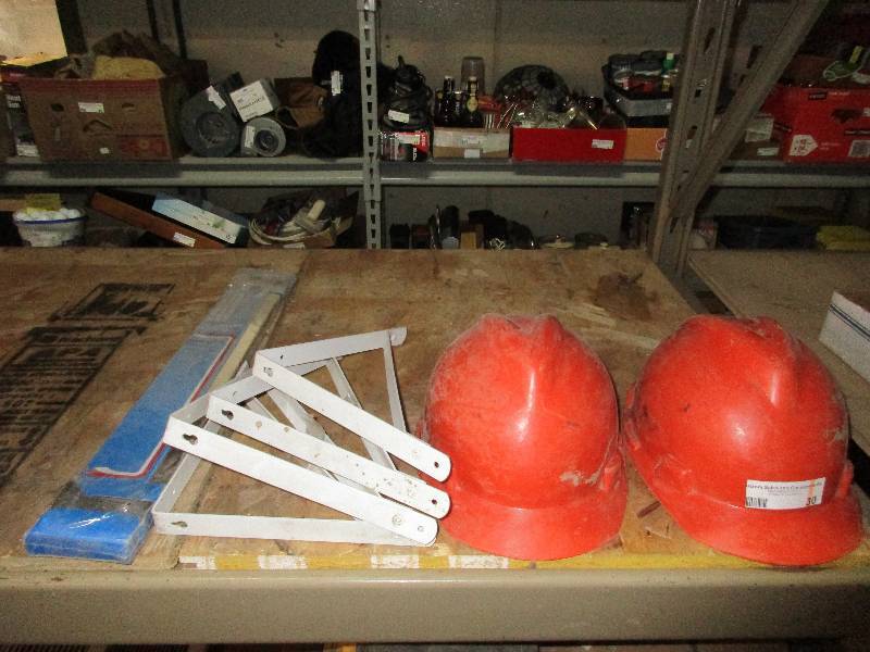 lot 30 image: 4 shelf hangers 2 hard hats and 1 new towel holder