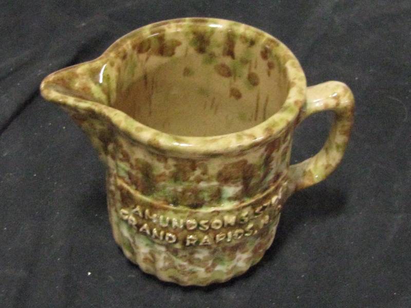 lot 36 image: BrownGreen Splatter Stoneware Advertising Pitcher