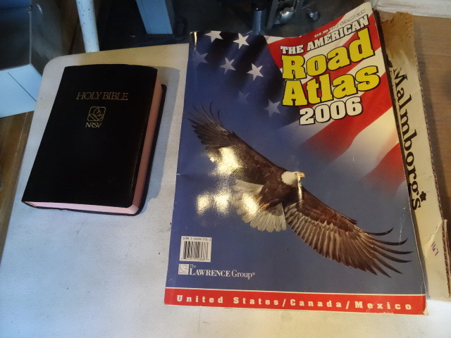 lot 213 image: Holy bible. American road atlas...