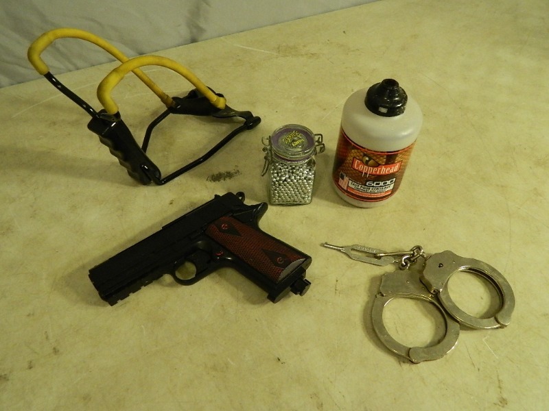 lot 19 image: BB Gun, Handcuffs, and More
