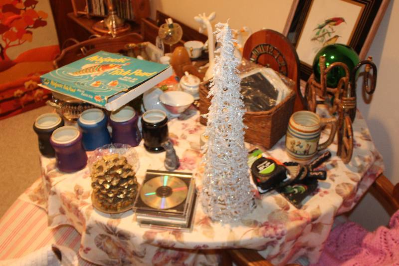 lot 36 image: Contents of Table Includes Table Decorations, CDs, And More
