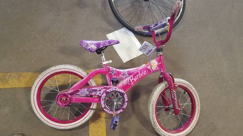 lot 313 image: Barbie with 12 inch Rim.