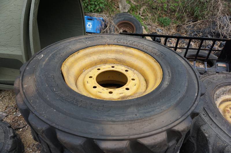 lot 8 image: Set of 4 - Caterpillar Brand Skid Loader Skid Steer Tires and Rim