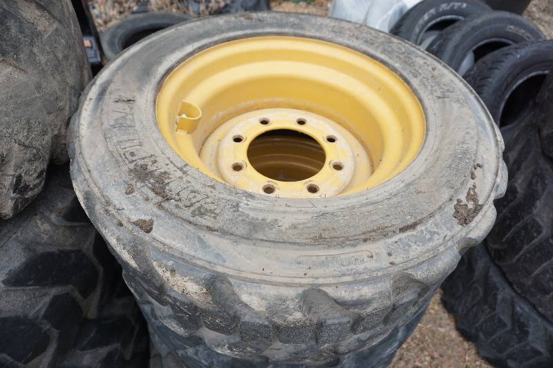 lot 10 image: Set of 4 - Caterpillar Brand Skid Loader Skid Steer Tires and Rim