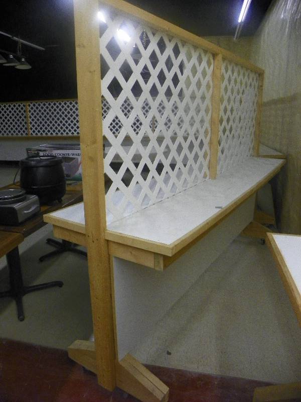 lot 82 image: Lattice Room divider with built in shelf on each side, on wheels with brakes. Approx 8 3 long x 6 tall x 27.5 wide