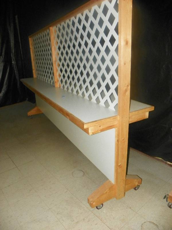 lot 80 image: Lattice Room divider with built in shelf on each side, on wheels with brakes. Approx 11 8 long x 6 tall x 27.5 wide
