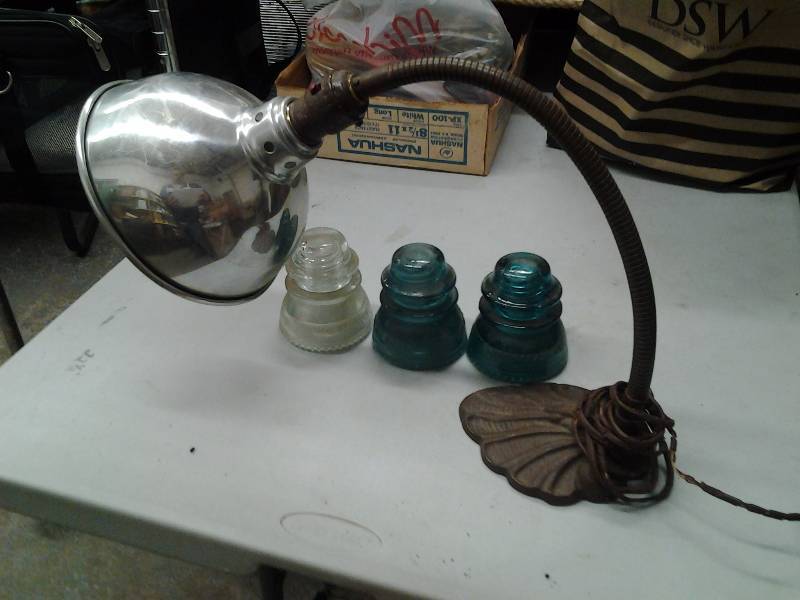 lot 44 image: Cast Iron Base Lamp, 3-Old Glass Telephone Line Insulators