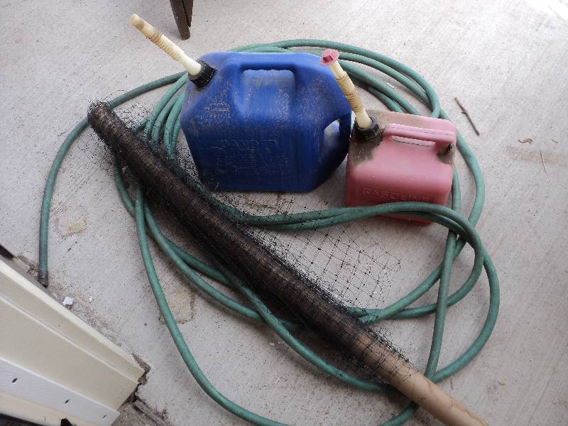 lot 51 image: hose, netting, 2 gas cans...