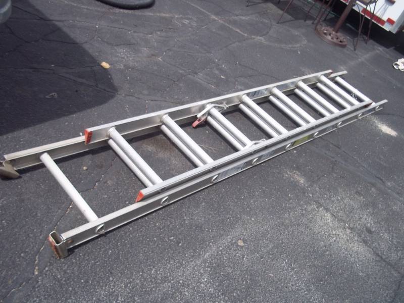 lot 15 image: Werner extension ladder. Extends out 13 foot only.  200# rating.