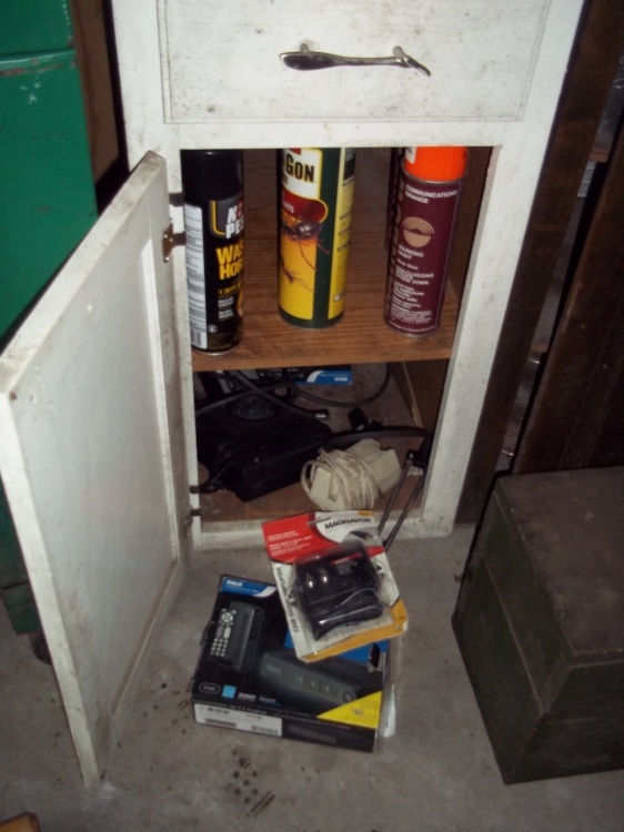 lot 23 image: Contents of shelves includes bug sprays and tv converters and chargers