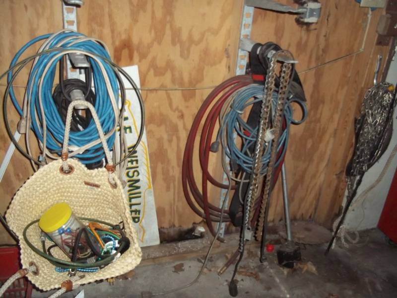 lot 61 image: Wall lot of bungees, extension cords, misc chains, etc