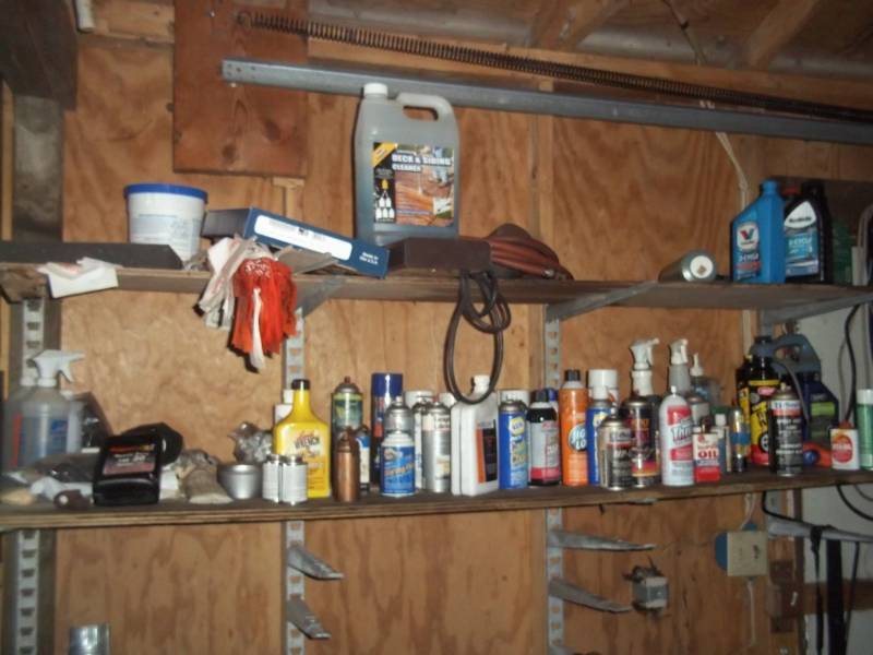 lot 62 image: 2 shelves of cleaning supplies, oils, etc