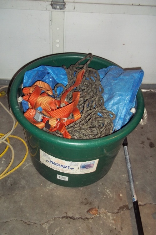 lot 82 image: Green tote basket with tarps and tarp straps