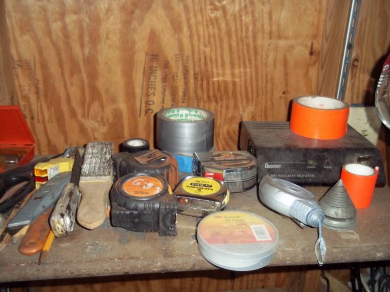lot 99 image: Shelf with tape measures, duct tape, screws,etc