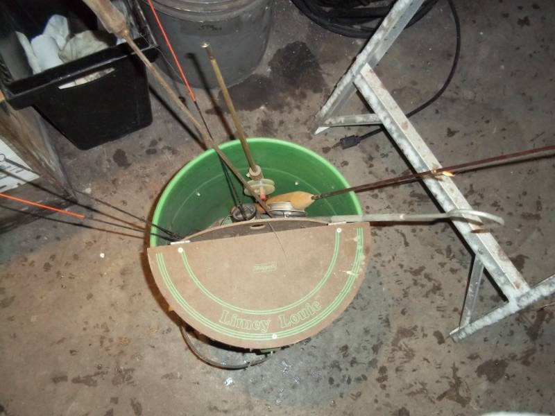 lot 105 image: Bucket with ice fishing rods