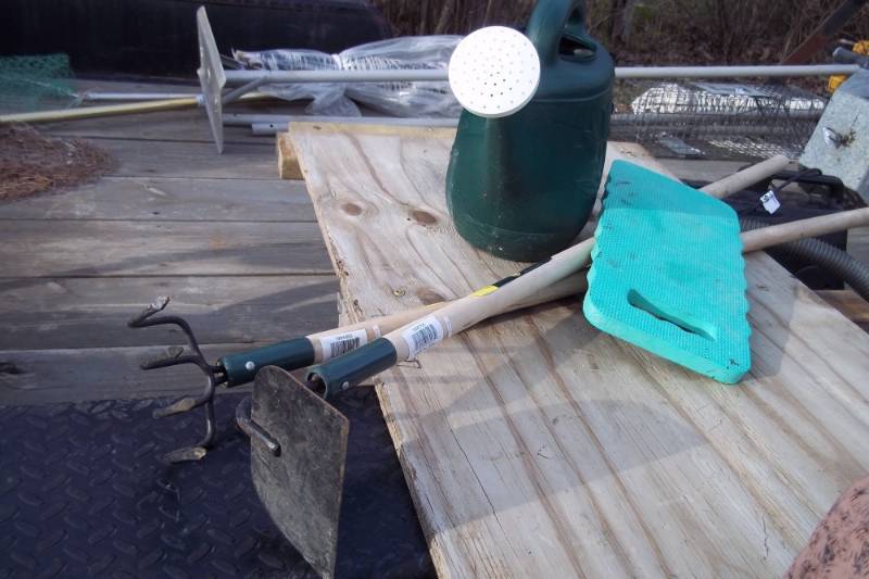 lot 255 image: Garden Lot includes waterer, knee pad, hoe,and dirt fork