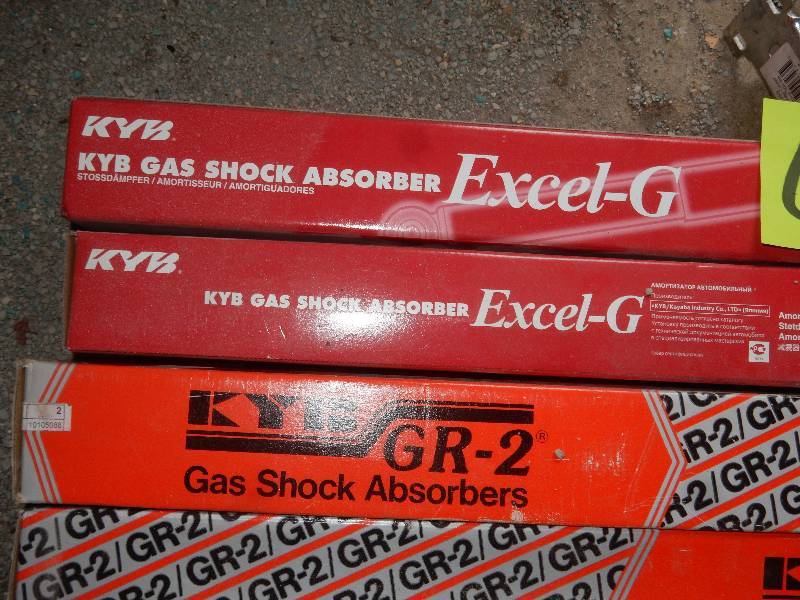 lot 66 image: 2 New KYB Gas Shock Absorbers  2 KYR GR2 Shock Absorbers.. 3 steel casters